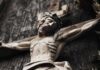 Wooden crucifix of a bearded figure with outstretched arms