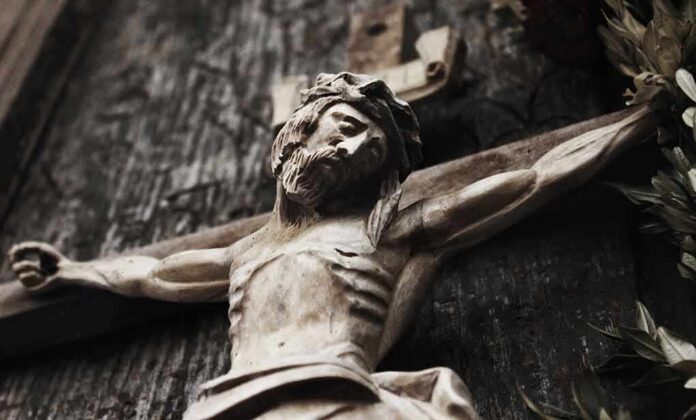 shutterstock_546970234 Wooden crucifix of a bearded figure with outstretched arms