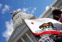 ‘Take Out LA?’ California Erupts California state flag in front of a white domed capitol building