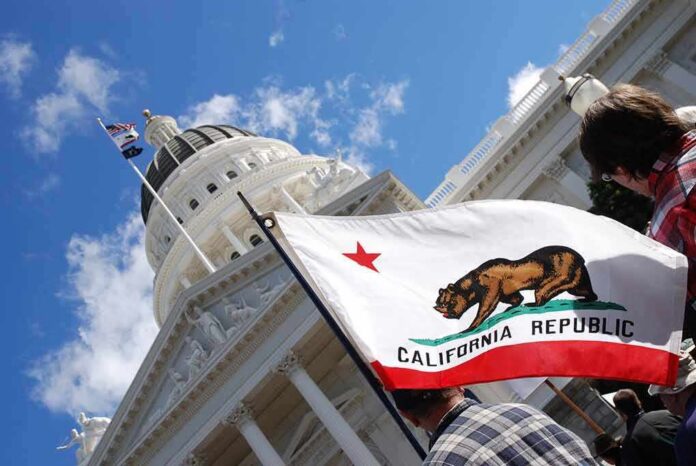shutterstock_642199051 California state flag in front of a white domed capitol building