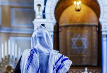 Orthodox Exodus – Antisemitism Fears Spark Florida Move Person in white and blue prayer shawl facing ornate interior